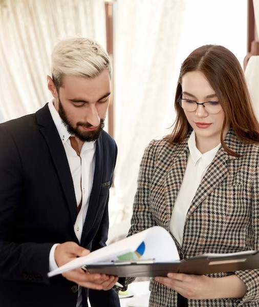 front-view-handsome-businessman-attractive-businesswoman-who-are-looking-file-with-documents_8353-10337